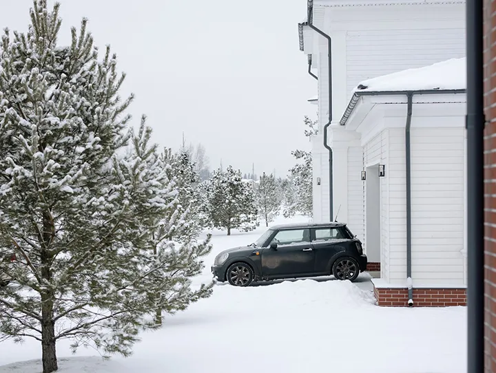 A car sitting by a home covered by a auto home insurance bundle in Syracuse